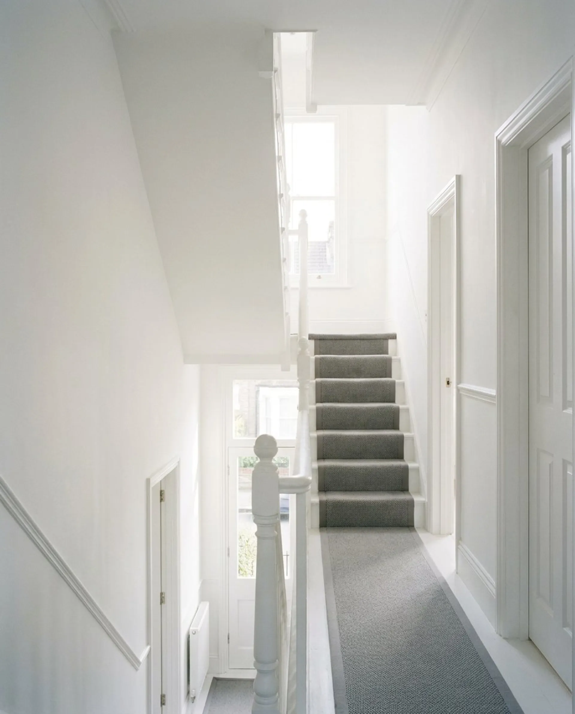 Interior photo of a white hallway and staircase