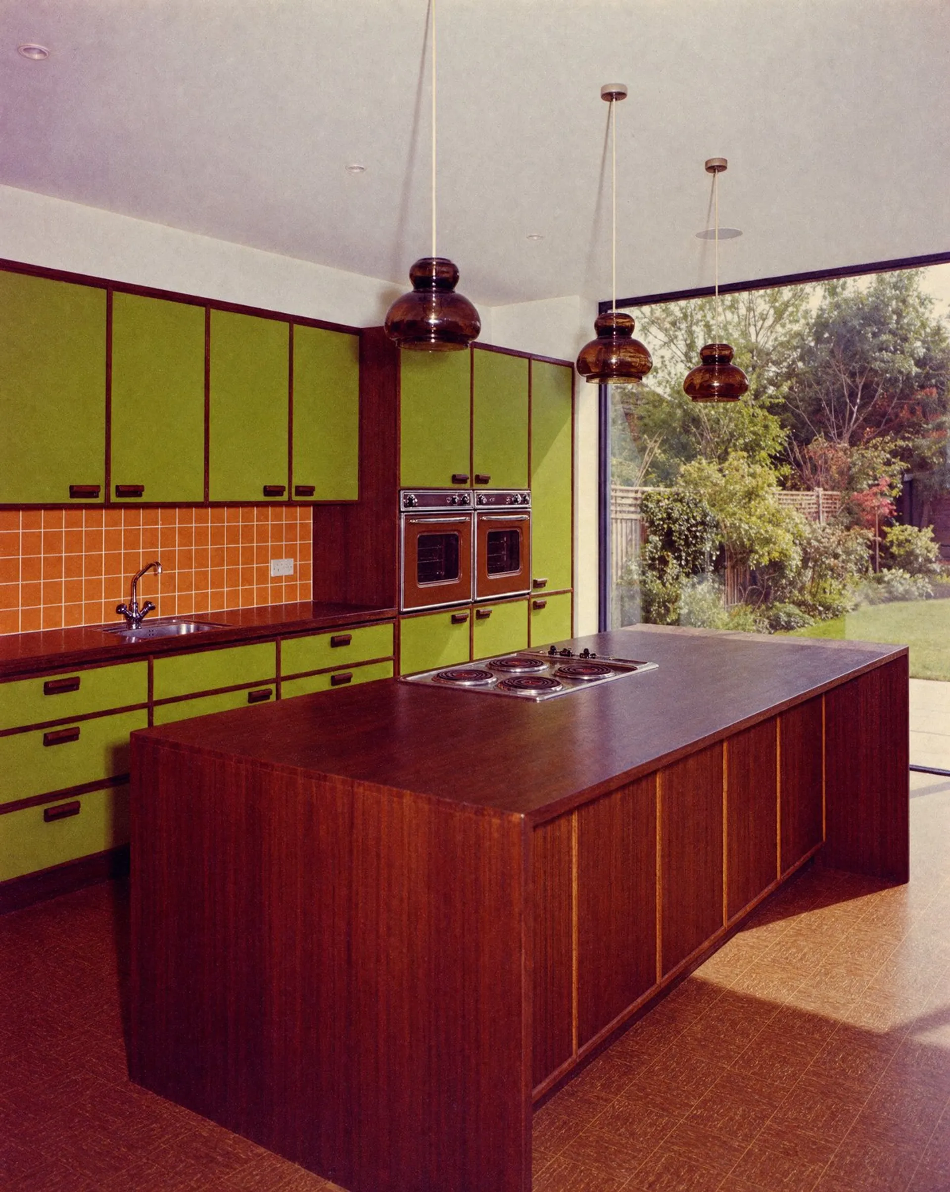 Krea 3 image of a modern kitchen restyled as a 1974 kitchen with avocado green cabinets and an orange tile backsplash