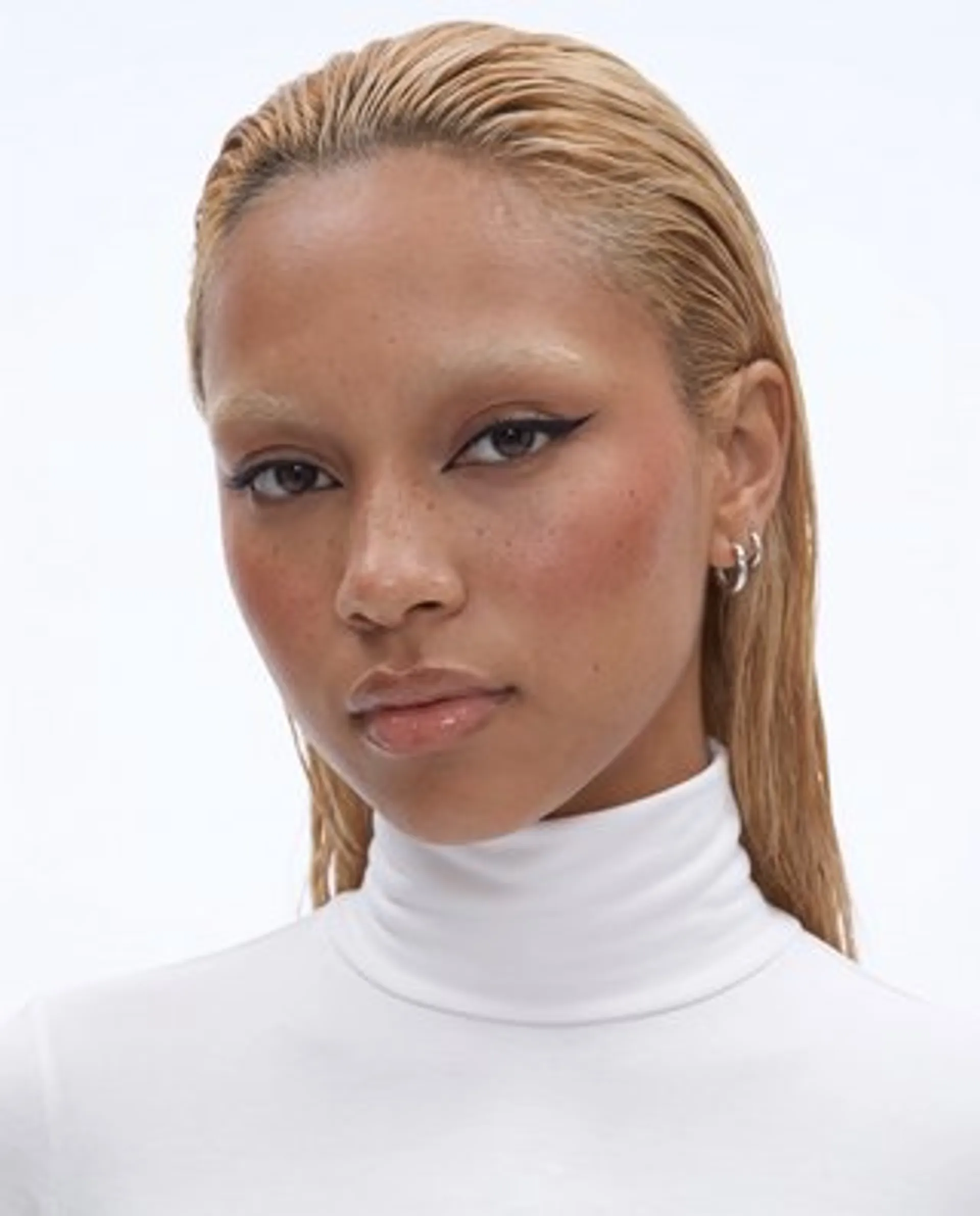 Reference 1: studio portrait of a woman with freckles and honey-blonde hair