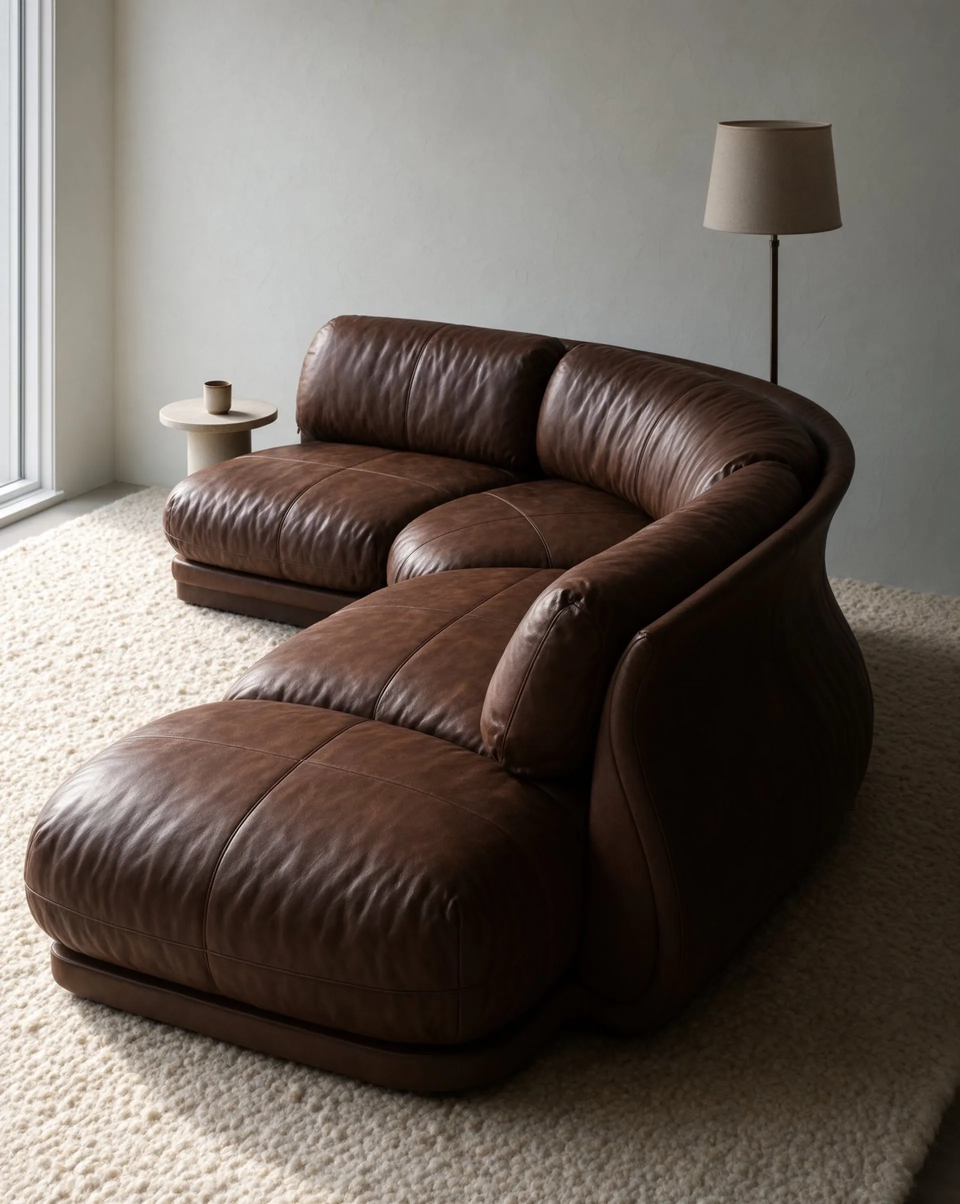 Krea 3 image of the same sofa in chocolate brown leather on a cream rug