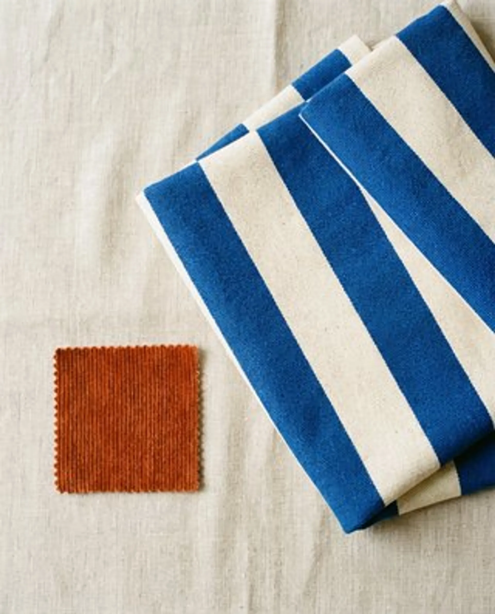 Reference: blue and cream striped fabric and a rust corduroy swatch
